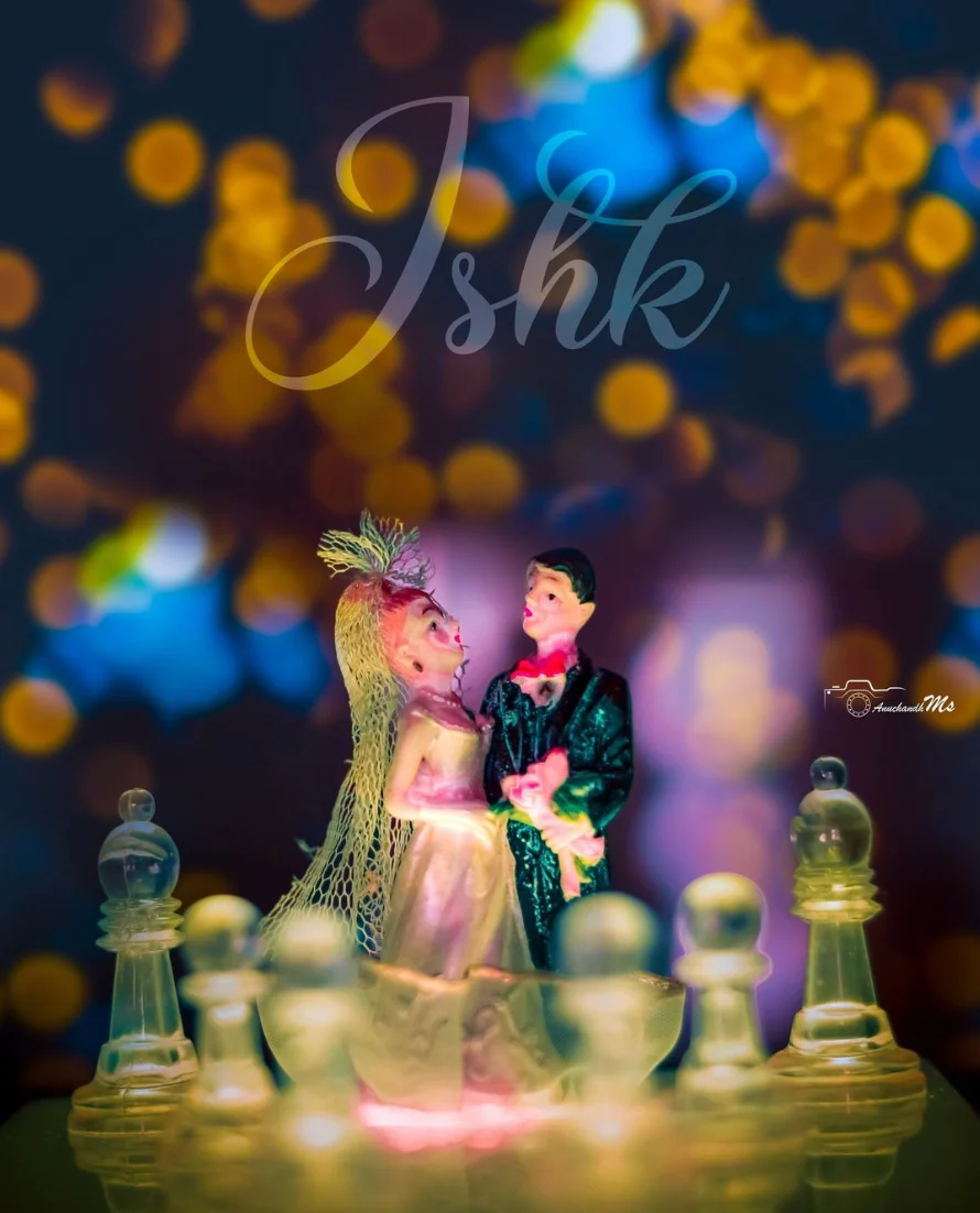 A couple figurine against colorful bokeh lights